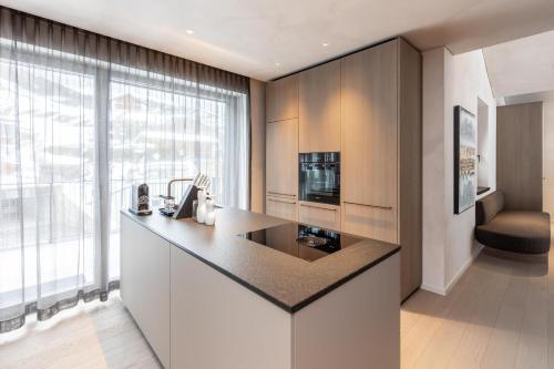 a kitchen with a large window and a counter top at Domenigs Luxury Apartments in Fiss