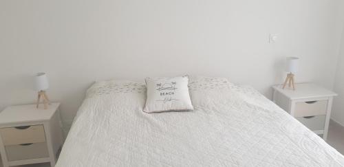 a white bed with a pillow on top of it at La Perséide - Maison neuve 900 m plage in Notre-Dame-de-Monts
