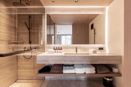 a bathroom with a large sink and a mirror at Domenigs Luxury Apartments in Fiss