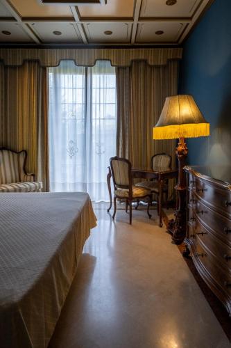 a bedroom with a bed and a table and a lamp at Il Castello Di San Gaudenzio in Cervesina