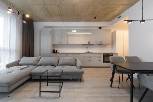 a living room with a couch and a table at Bossa Nova - modern 2 bedroom apartment in the center in Vilnius
