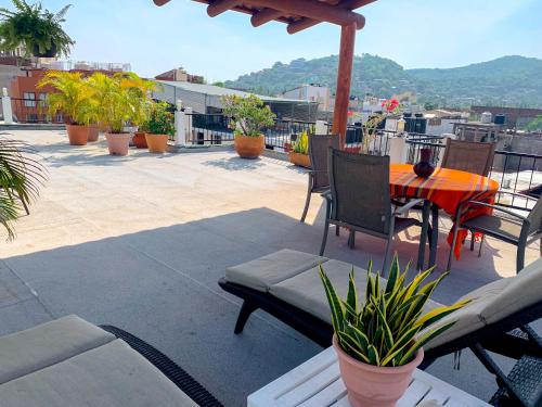 un patio con mesa y sillas en la azotea en Hotel Valle, en Zihuatanejo