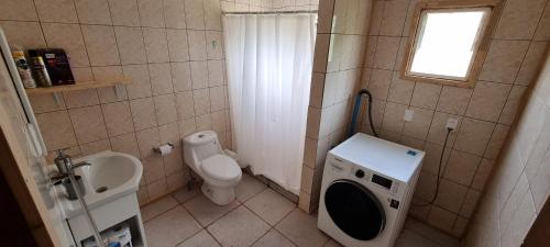 a small bathroom with a toilet and a sink at Casa en Dalcahue - Mira Mar in Dalcahue