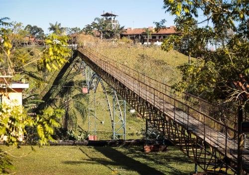 a suspension bridge over a hill with trees at Vale Encantado - Eco Park & Hotel in Biritiba-Mirim