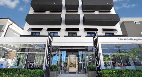 a building with a store front with signs in front at Hotel Europa Monetti in Cattolica