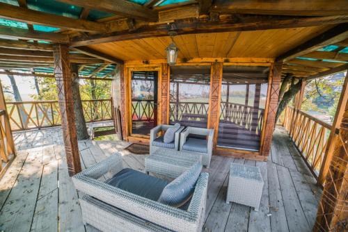 an overhead view of a porch with wicker furniture at Etno selo Stanišići Etno kuće in Dijelovi