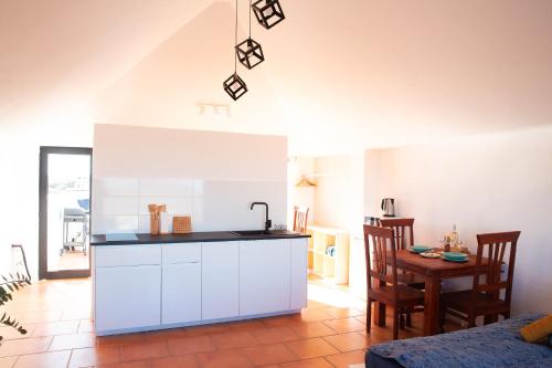 a kitchen with a sink and a table in a room at Castillo de Villaverde in Villaverde