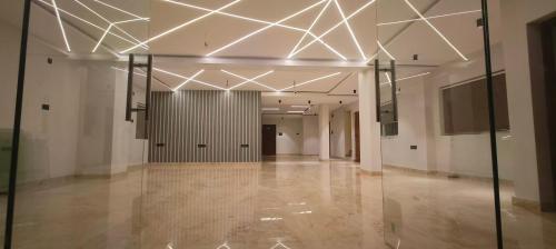 a hallway of a building with white walls and ceilings at Nebo Suites in Visakhapatnam