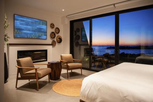 a bedroom with a bed and a fireplace and a large window at ViewPoint Hotel in York