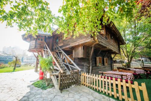 a wooden house with a staircase leading up to it at Etno selo Stanišići Etno kuće in Dijelovi