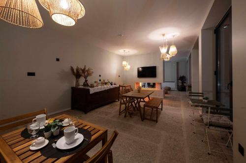 a living room with a table and chairs and a couch at Ermo Loft - Casas do Ermo in Fafe