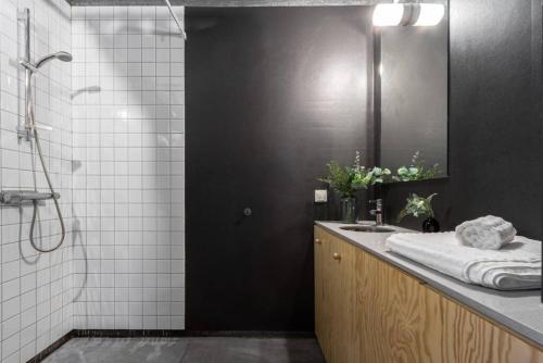 a bathroom with a sink and a mirror at Convinient Studio 25 min to city in Stockholm