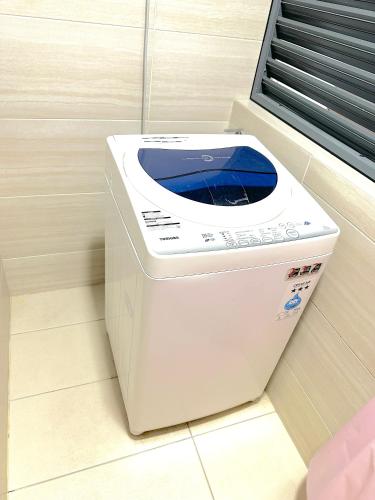 a washing machine sitting on the floor in a room at 3 Towers Jalan Ampang By Serenity Vacation Homes in Kuala Lumpur