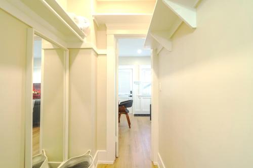a hallway with white walls and a room with a desk at The Heron On Ivy in San Diego
