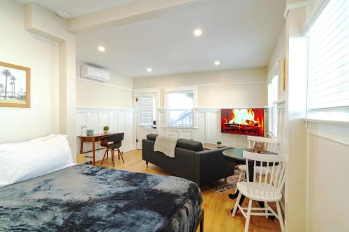 a bedroom with a bed and a living room with a fireplace at The Heron On Ivy in San Diego