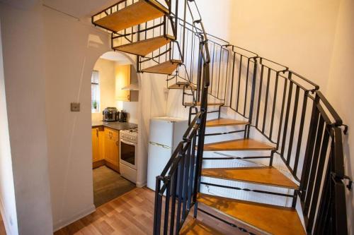 a spiral staircase in a home with a kitchen at Entire 1 Bedroom House in Manchester in Manchester