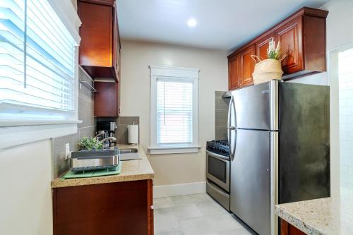 a kitchen with a stainless steel refrigerator and a sink at The Heron On Ivy in San Diego