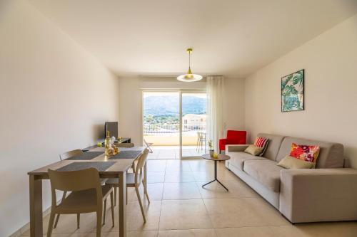 a living room with a couch and a table at Residence A Marina in Lumio