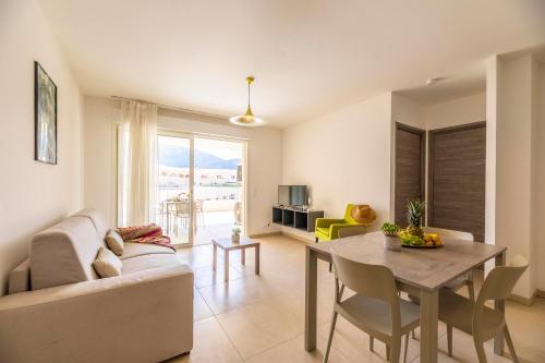 a living room with a couch and a table at Residence A Marina in Lumio