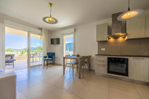 a kitchen with a table and a dining room at Residence A Marina in Lumio