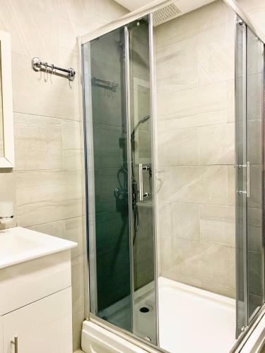 a shower with a glass door in a bathroom at Memories House in Bakuriani