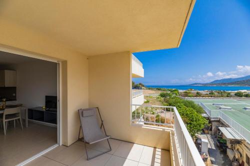 a balcony with a chair and a view of the ocean at Residence A Marina in Lumio