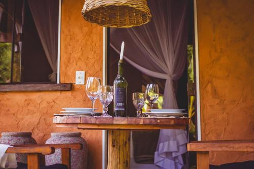 a table with glasses and a bottle of wine on it at Quinta da Bocaina in Amparo