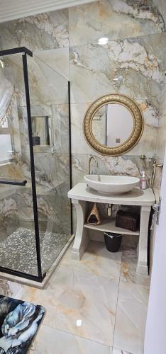 a bathroom with a sink and a mirror at Grazia Overnight accommodation in Harrismith