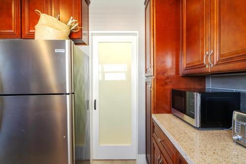 a kitchen with a stainless steel refrigerator and a microwave at The Heron On Ivy in San Diego