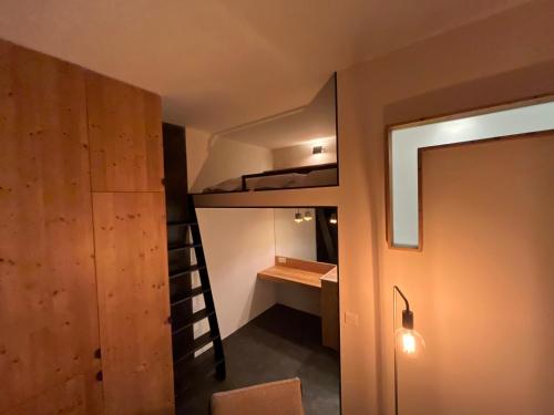 a small room with a bunk bed and a desk at un nid avec balcon in Saint-Gervais-les-Bains