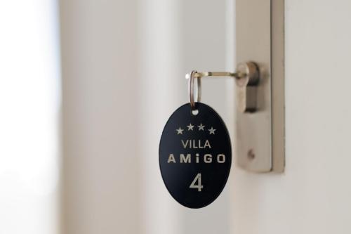 a door tag with the words villa amico on it at Villa Amigo in Podstrana