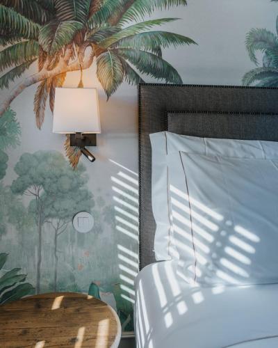 a bedroom with a bed with a lamp and a table at AlmaLusa Alfama in Lisbon