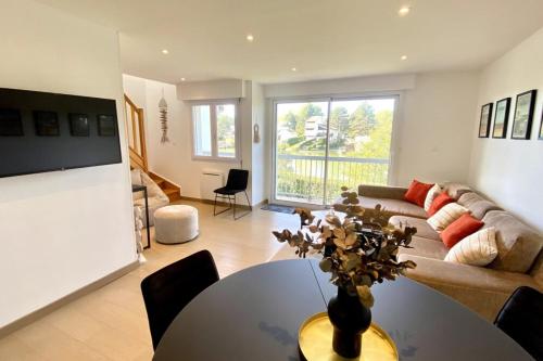 a living room with a couch and a table at Superb duplex with lake view for 6 people in Le Touquet-Paris-Plage