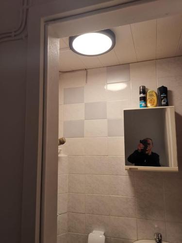 a bathroom with a shower with a picture of a man at Lagesche str.63 Detmold (zentralliegend) in Detmold