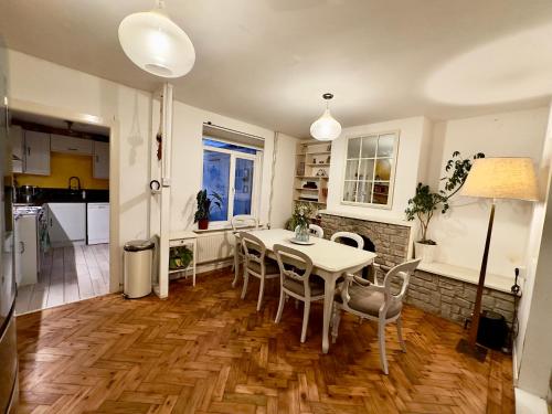 una cucina e una sala da pranzo con tavolo e sedie di Ben & Maria's Guesthouse a Bath