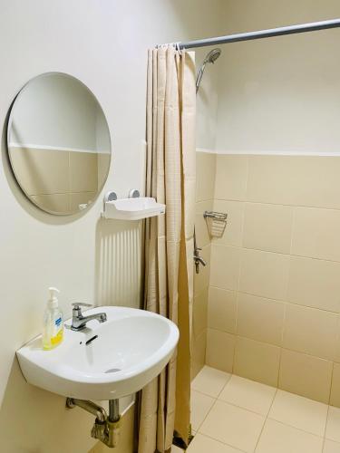 a bathroom with a sink and a shower at EZ Cityscape Studio at Loop Towers Limketkai in Cagayan de Oro