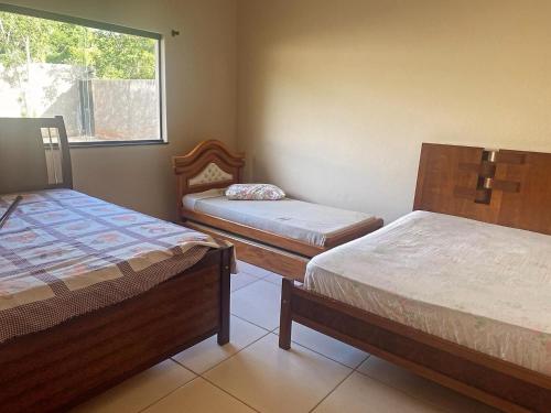 a room with two beds and a window at Sítio Maravilhoso a 40min de BH! in Lagoa Santa