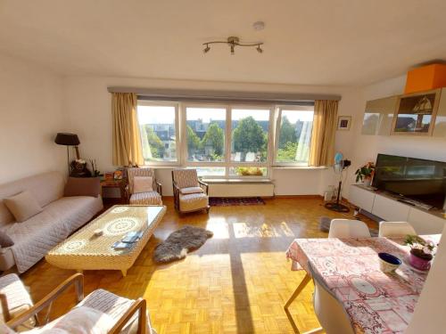 a living room with a couch and a table at Wonderful stay Monet in Ghent