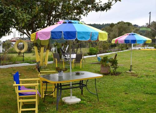 a table and chairs under an umbrella in a yard at Zina's House in Troulos