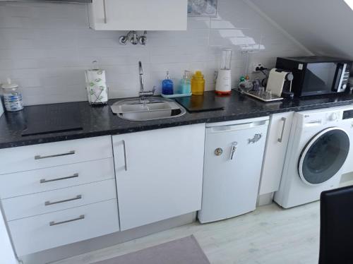 a kitchen with a sink and a washing machine at Seixal Yachting Bay Apartments in Seixal