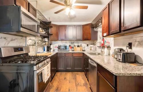 a kitchen with stainless steel appliances and wooden cabinets at Atlanta Hartsfield International Connection in Atlanta