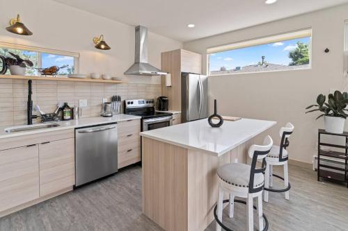 a kitchen with a counter and two stools at Beautiful Denver Carriage House in Denver