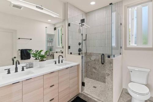 a bathroom with a shower and a toilet and a sink at Beautiful Denver Carriage House in Denver