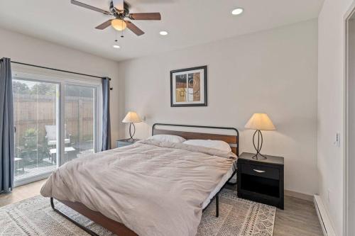 a bedroom with a bed and a ceiling fan at Beautiful Denver Carriage House in Denver