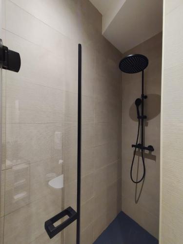 a shower with a glass door in a bathroom at Pensión Boutique Caravan Cinema in Bilbao