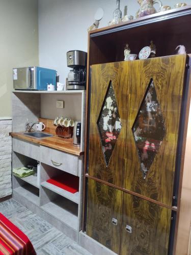 a kitchen with a wooden cabinet with a counter at Your Place in Florida