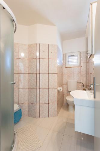 a bathroom with a sink and a toilet at Villa Amigo in Podstrana