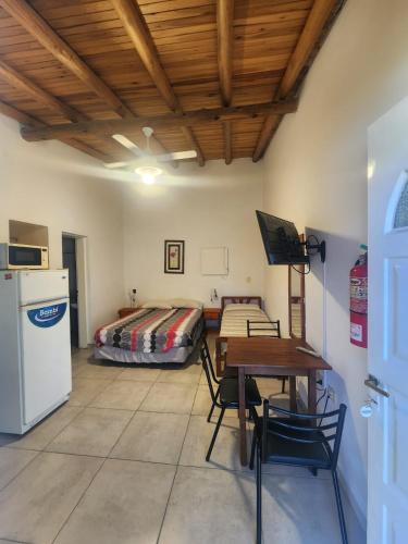 a room with a table and a bed and a table and chairs at Complejo El Ensueño in Colón