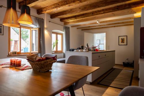 a kitchen with a wooden table and a dining room at Ferienhaus am Park in Grafenau