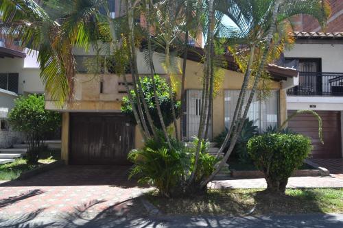 a building with palm trees in front of it at Espacio seguro, amplio y acogedor in Medellín